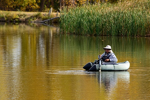 A person on the water fishing at St. Vrain State Park.