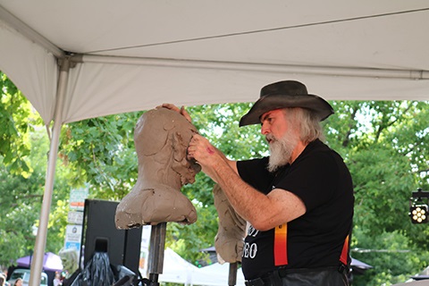 A man designing a sculpture.